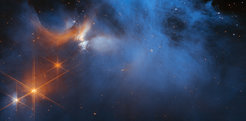 This image by the NASA/ESA/CSA James Webb Space Telescope features the central region of the Chameleon I dark molecular cloud, which resides 630 light years away. The cold, wispy cloud material (blue, centre) is illuminated in the infrared by the glow of the young, outflowing protostar Ced 110 IRS 4 (orange, upper left). The light from numerous background stars, seen as orange dots behind the cloud, can be used to detect ices in the cloud, which absorb the starlight passing through them.